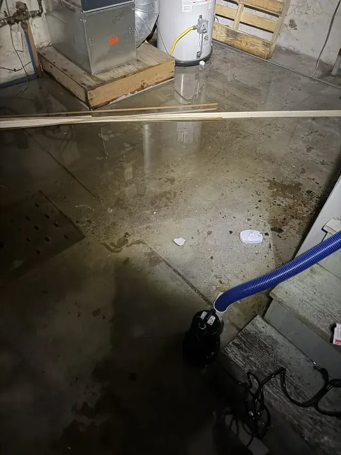 An extraction hose removes standing water from a wet utility room floor