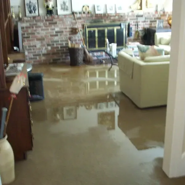 Standing water spreads across the floor of an indoor room